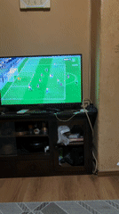 Young men watch soccer match on TV in Sopot