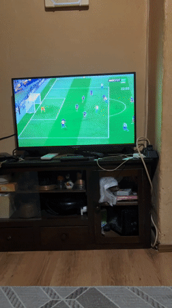 Young men watch soccer match on TV in Sopot