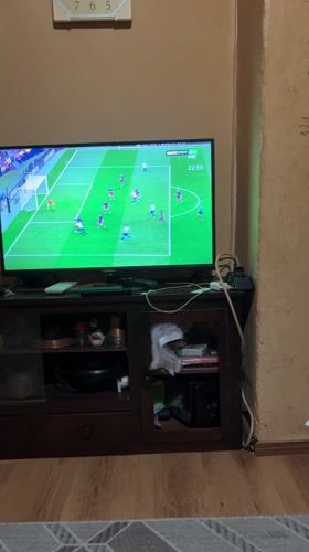 Young men watch soccer match on TV in Sopot