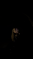 Woman Takes Mirror Selfies in Dark Room, Mexico