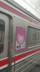 Onboard a red-striped commuter train rolling through Bekasi