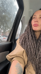 Woman observed in car during rainy morning in Chaikovsky