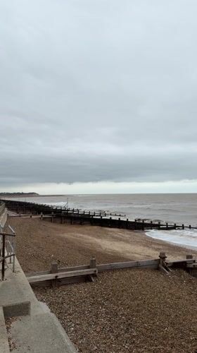 Cloudy day at East Suffolk beach with choppy seas