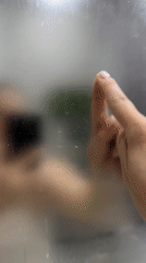 Heart drawn in bathroom steam, selfie taken in foggy mirror