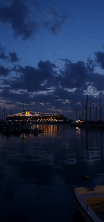 Cruise ship lights illuminate Montenegro harbor at nightfall