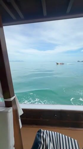 Longtail boat crossing turquoise waters off Ko Samui