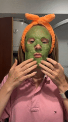 Woman conducts skincare routine in Bečići bathroom