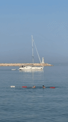 Quiet morning on the Adriatic, sailboat anchored off Bar's pebble beach.