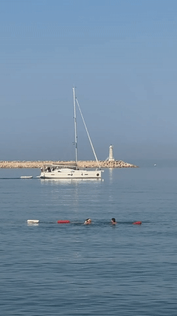 Quiet morning on the Adriatic, sailboat anchored off Bar's pebble beach.