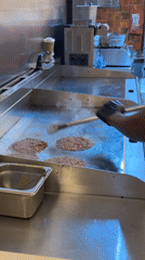 Cape Town kitchen worker prepares fast food meals