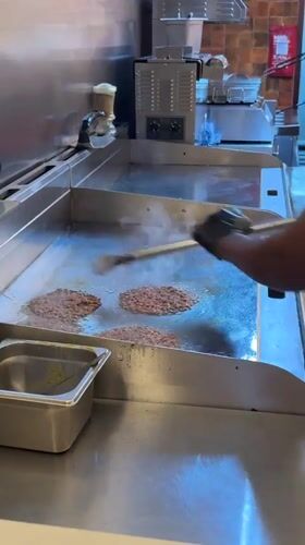 Cape Town kitchen worker prepares fast food meals
