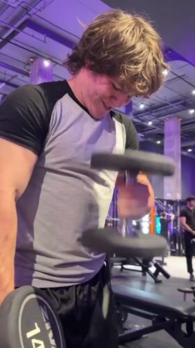Gym workout session in a purple-lit Kazan fitness center