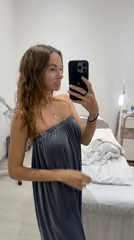 Woman takes selfie in gray wrap at Kuta spa