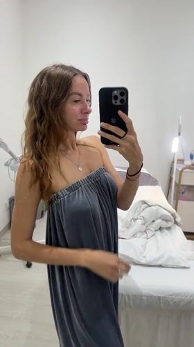 Woman takes selfie in gray wrap at Kuta spa