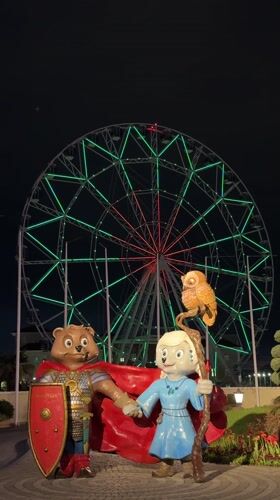 Nighttime scenes document statues, Ferris wheel in Sirius, Russia