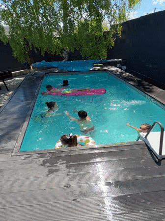 Children enjoy pool time in Goryachevodsky backyard gathering