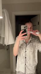 Woman records evening tooth-brushing routine in Warsaw bathroom