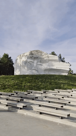 Hillside face sculpture and amphitheater documented in Arseniev, Russia