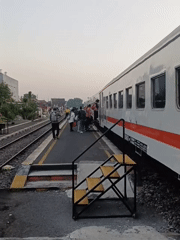 Passenger activity at Gedangan station as a KAI train stops