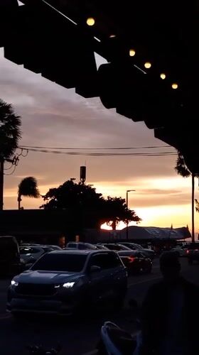 Sunset street scene captured from covered vantage in Pattaya
