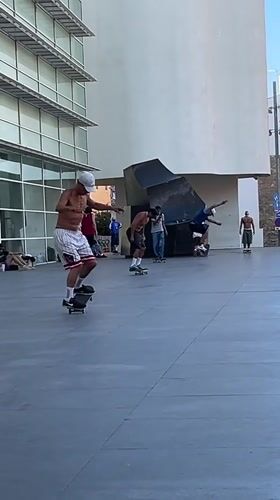 Barcelona Pride parade meets street skating on a sunny afternoon