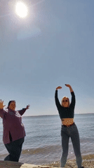 Women enjoy sunny morning beach activities in Russia