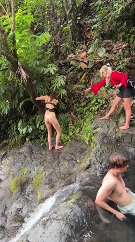 Three people gather at tropical pool in Sidemen