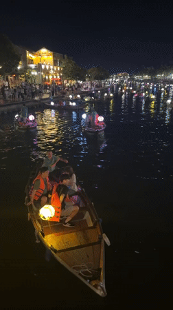 Lantern boats drift the Thu Bon River in Hoi An at night