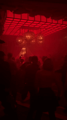 Moscow nightclub buzzes with activity under dramatic red lighting
