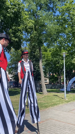Street performers and activities at a summer fair in Buk, Poland