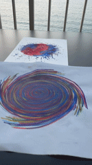 Colorful swirl paintings on a table in Calp