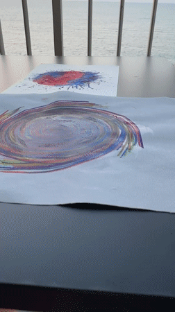 Colorful swirl paintings on a table in Calp