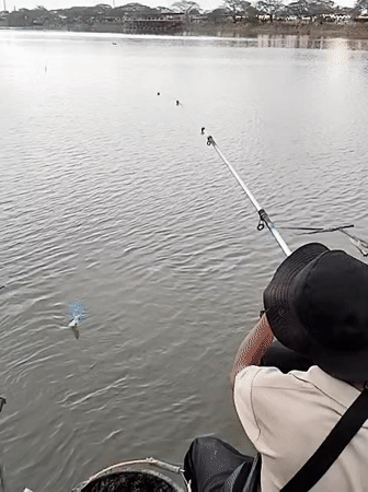 Fishermen gather at Lhokseumawe waterfront on overcast morning