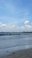 Morning beach activity and local traffic captured in Kuta Selatan