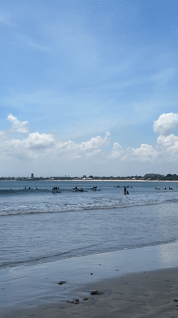 Morning beach activity and local traffic captured in Kuta Selatan