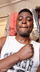 Man takes playful selfies at clothing store in Nigeria