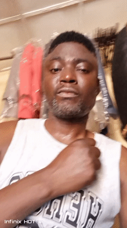 Man takes playful selfies at clothing store in Nigeria