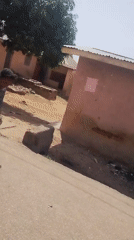 Girl jump ropes, soccer player stands on street