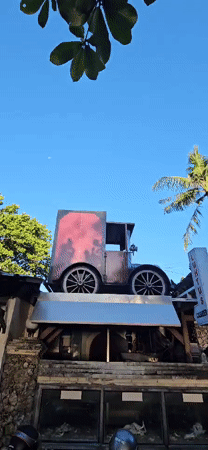Vintage-themed coffee shop displays antique car, bicycle clocks in Denpasar