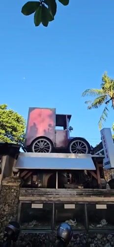 Vintage-themed coffee shop displays antique car, bicycle clocks in Denpasar