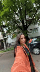 Woman Documents Spring Flowers During Morning Walk in Pleven