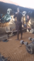 Man exercises with homemade weights in outdoor gym