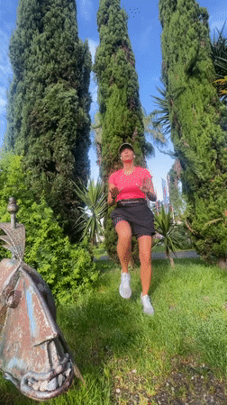 Woman exercises among metal sculptures in Sochi park