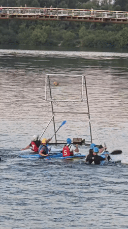 Kayak water polo and riverside leisure in Kyiv at dusk