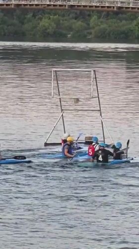 Kayak water polo and riverside leisure in Kyiv at dusk