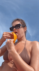 Woman enjoys mango and beach time in Choeng Thale