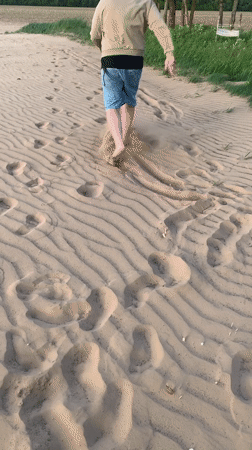Person documents sandy terrain and sand messages in Belarus