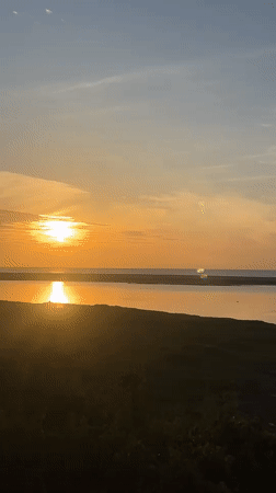 Golden sunset over Arugam Bay's calm coastal waters