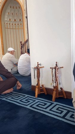 Friday morning prayers at a green-domed mosque in Karamanas