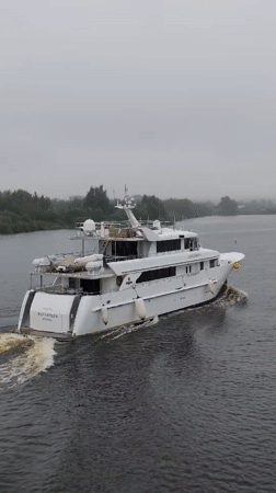Yachts and cargo vessels moving through open water and canals